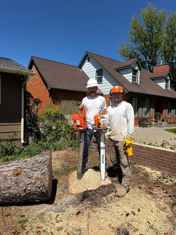 Raptor Tree Service crew with chainsaws after a job